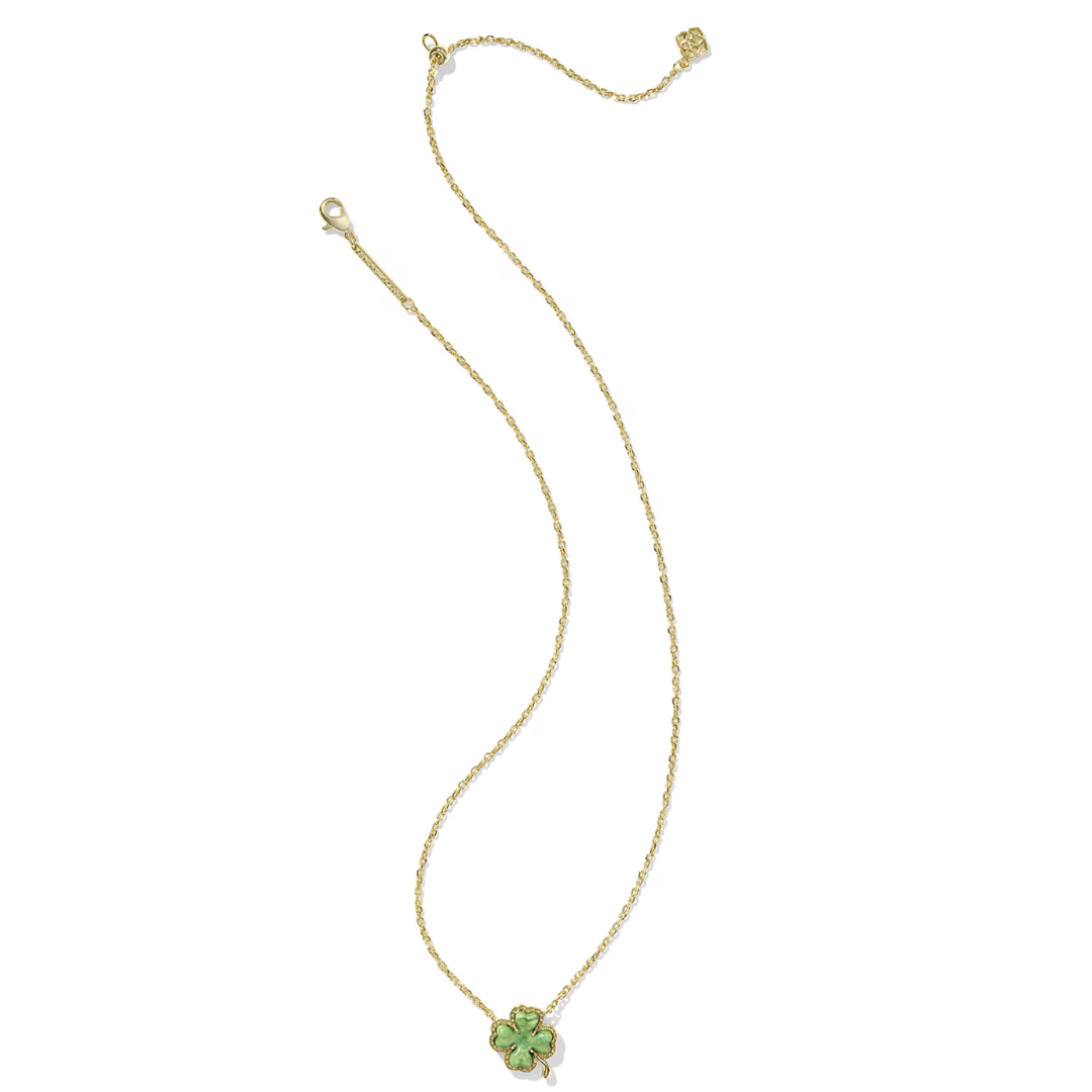 Gold necklace with a green pendant on a white background