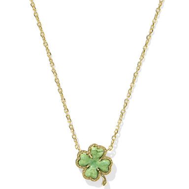 Gold necklace with a green four-leaf clover pendant on a white background